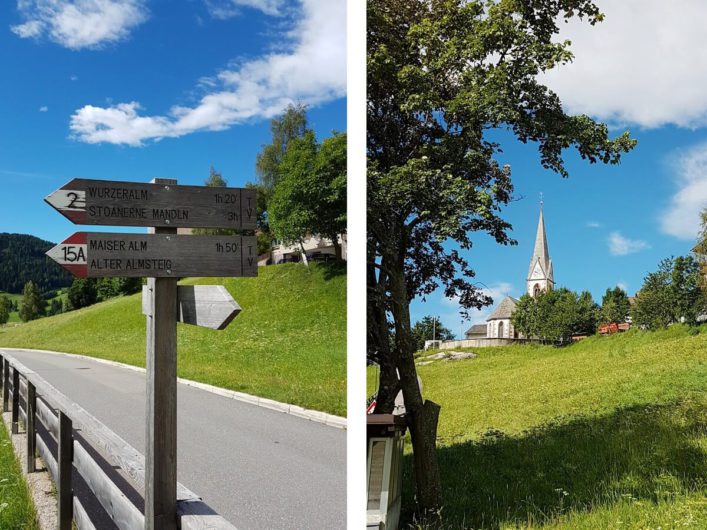 Wanderschilder in Hafling und Blick zurück auf die Dorfkirche