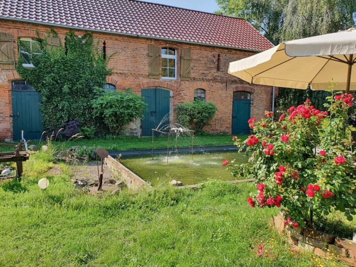 Innenhof des Kunsthof Dahrenstedt mit Blumen und Springbrunnen